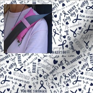 May include: A white fabric with a repeating pattern of blue ribbon symbols, hearts, and the text "Fight", "Every day is a victory", "No Surrender", "You are stronger", and "Kick cancer's butt".