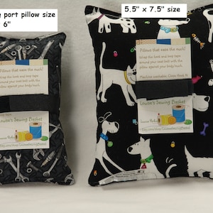 May include: Two black and white fabric pillows with different patterns. The smaller pillow is 3 inches by 6 inches and features a pattern of wrenches and other tools. The larger pillow is 5.5 inches by 7.5 inches and features a pattern of white dogs and cats on a black background. Both pillows have a black strap and a white tag that says "Louise's Sewing Basket".