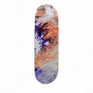 May include: A skateboard deck with a colorful abstract design featuring swirls of orange, white, and purple paint.