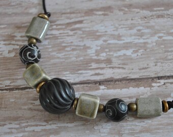 Men's Necklace of carved antiqued jade beads, ceramic beads, carved wooden focal bead on brown leather cord , masculine, rugged