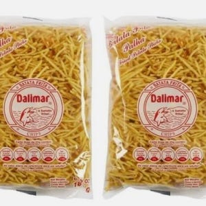 May include: Two identical clear plastic bags filled with thin, golden-yellow fried potato sticks. Each bag features a circular red and white logo with the text Dalimar, a dolphin illustration, and nutritional information printed on the front.
