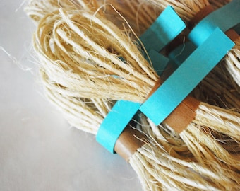 May include: Bundles of natural fiber twine tied together with blue tape.