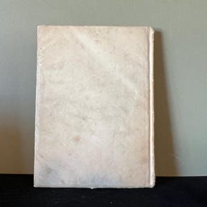 May include: A plain white book cover with a slightly textured surface.