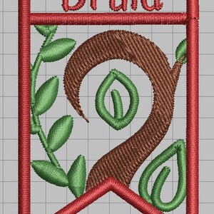 May include: Embroidered banner with the word "Druid" in red thread. The design features a brown, stylized tree trunk with green leaves and a red border. The banner is set against a gray grid background.