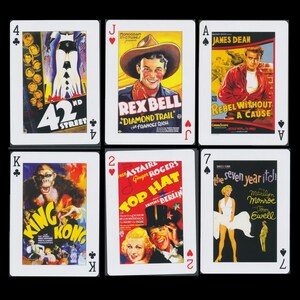 May include: A set of playing cards featuring movie posters from classic films. The cards include the King of Spades, the 7 of Spades, the Jack of Hearts, the 2 of Hearts, the Ace of Spades and the 4 of Clubs. The posters feature films such as "King Kong", "The Seven Year Itch", "Top Hat", "Rebel Without a Cause", "Diamond Trail", and "42nd Street".