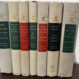 May include: A collection of vintage books with titles including "The Making of Man" and "The Scarlet Letter." The books have green, red, and black spines with gold lettering and a running figure logo. The books are from the Modern Library series.