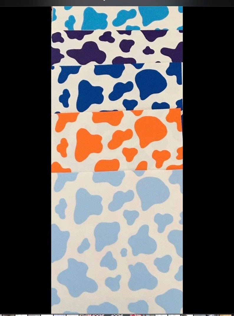 May include: Five fabric swatches with a cow print pattern. The swatches are in different colors: light blue, purple, blue, orange, and a lighter shade of blue.