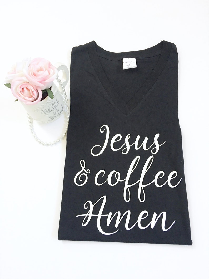 May include: Black V-neck t-shirt with white text that reads "Jesus & coffee Amen".