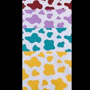 May include: Five different cow print patterns on white paper. The patterns are purple, maroon, lavender, teal, and yellow.