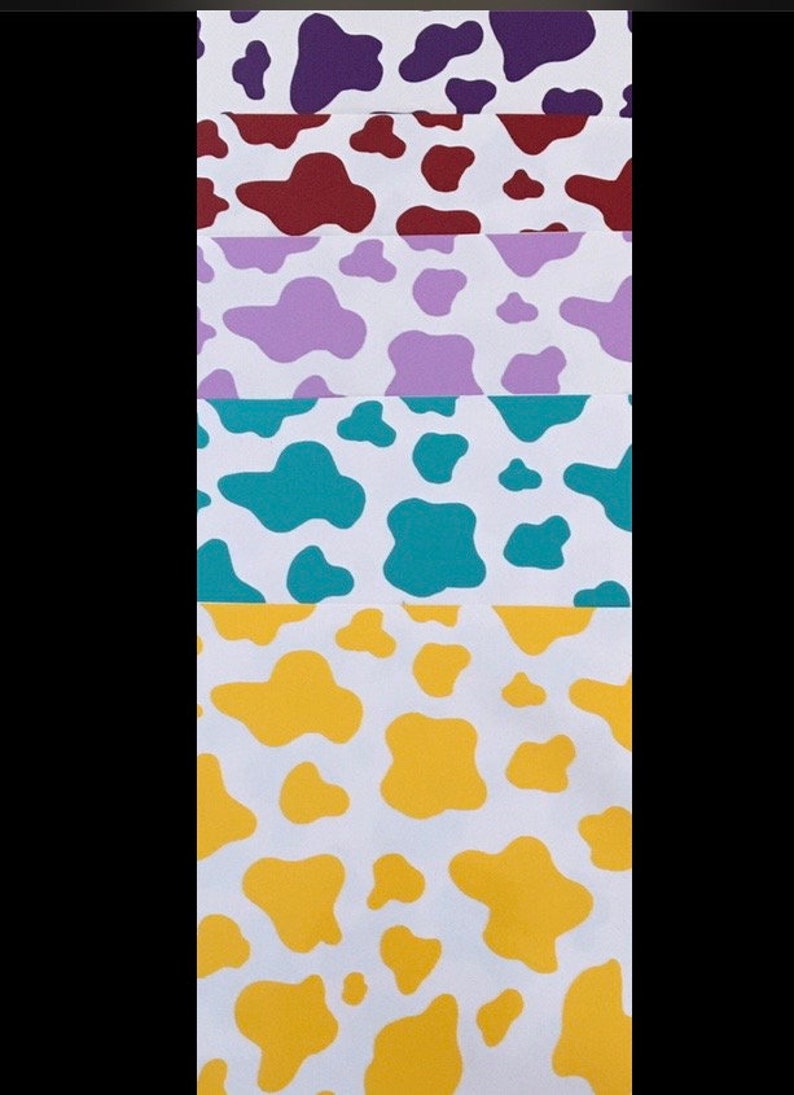 May include: Five different cow print patterns on white paper. The patterns are purple, maroon, lavender, teal, and yellow.