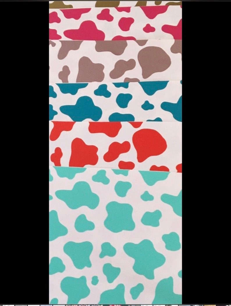 May include: A set of six cow print fabric swatches in different colors, including pink, brown, teal, orange, and turquoise.