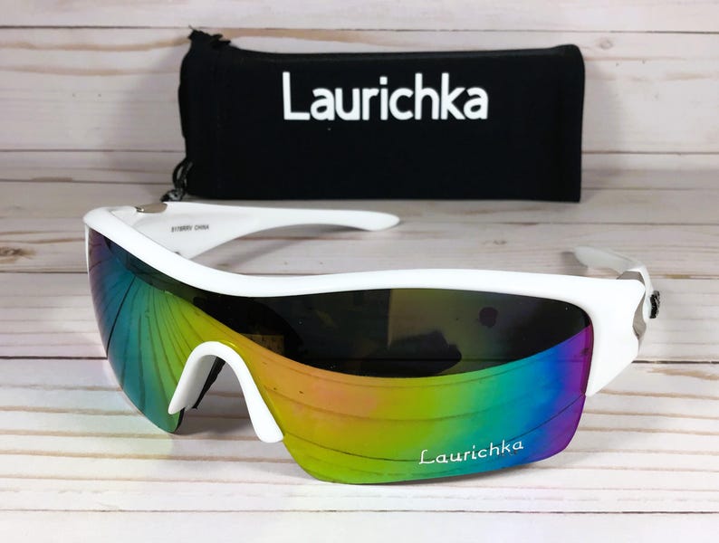 May include: White wraparound sunglasses with a rainbow iridescent lens and the word "Laurichka" printed on the frame.