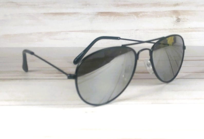 May include: Aviator sunglasses featuring a thin black metal frame and reflective silver mirrored lenses. The design includes a double bridge across the top and slender black temples with curved ends, providing a classic look with a metallic finish.