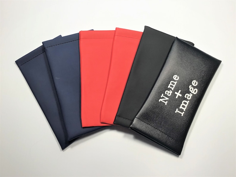 May include: Five fabric pouches in different colours, with the top pouch being black and having the text "Name + Image" embroidered on it in white.