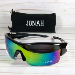 May include: Black sunglasses with a rainbow iridescent lens and a black carrying case with the name "JONAH" printed on it.