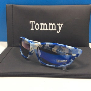 May include: Blue and white camouflage sunglasses with a black case. The case has the word "Tommy" printed on it.