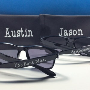 May include: Two pairs of black sunglasses with personalized engravings. One pair says "Austin Best Man" and the other says "Jason Groomsman".