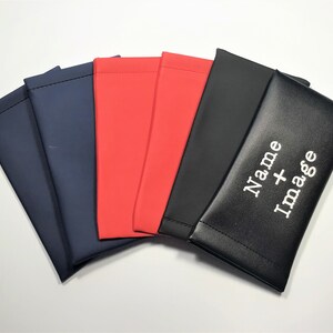 May include: Five different colored fabric pouches, with the top pouch being black and having the text "Name + Image" embroidered on it in white.