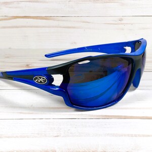 May include: Blue and black wraparound sunglasses with blue mirrored lenses. The sunglasses have a logo on the side.