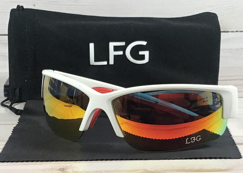 May include: White sunglasses with reflective orange and yellow lenses featuring the text LFG on the bottom right lens. The sunglasses are accompanied by a black drawstring pouch with the white text LFG printed on the front surface.