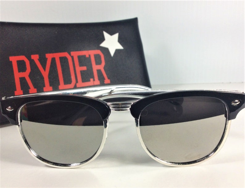 May include: Black sunglasses with silver trim and mirrored lenses. The sunglasses are in a black case with the word "RYDER" in red letters and a white star.