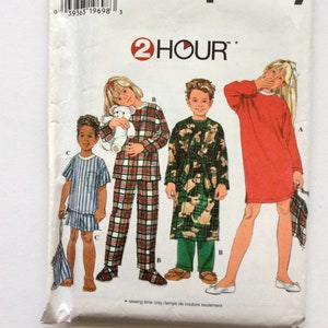 May include: Simplicity sewing pattern number 7407 for children's pajamas and a robe. The pattern includes three designs: a red nightgown, a plaid pajama set, and a robe with a dog print. The pattern is for sizes BB, 5, 6, 7, and 8. The pattern is labeled "2 Hour" and includes instructions for sewing.
