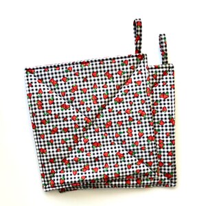 May include: Two black and white gingham pot holders with a strawberry print. The pot holders have a loop for hanging.