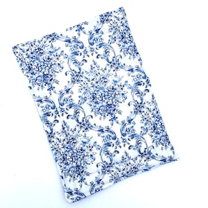 May include: A white rectangular tray with a blue and white floral pattern. The tray has a slightly raised edge.