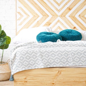 Natural solid wood headboard or bed board with platform bed frame. Unique and eclectic design. Handcrafted in the USA. Heirloom quality furniture. Sustainably sourced materials. Bedroom.