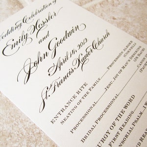 May include: Wedding ceremony program with the names Emily Horster and John Goodwin, the date April 17, 2012, and the location St. Francis Xavier Church. The program lists the order of events, including the entrance rite, seating of the family, processional, bridal processional, liturgy of the word, first reading, responsorial psalm, and second reading.