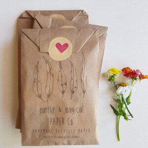 May include: Stack of brown paper envelopes with a red heart sticker and the text "earthy & magical PAPER CO. HANDMADE RECYCLED PAPER. MADE IN THE BLUE MOUNTAINS, NSW, AUSTRALIA."