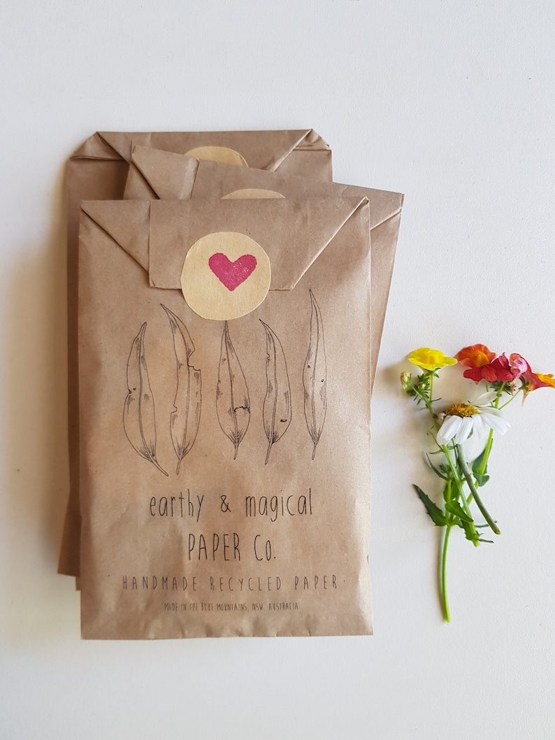 May include: Stack of brown paper envelopes with a red heart sticker and the text "earthy & magical PAPER CO. HANDMADE RECYCLED PAPER. MADE IN THE BLUE MOUNTAINS, NSW, AUSTRALIA."