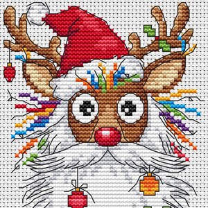 May include: A cross-stitch design of a reindeer wearing a Santa hat. The reindeer has a brown face, large eyes, and a red nose. Its antlers are decorated with colorful lights and ornaments, and it has a white beard.