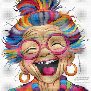 May include: A cross-stitch pattern featuring a laughing person with a vibrant, multi-coloured hair bun, wearing large pink circular glasses, gold hoop earrings, and a chunky multi-coloured bead necklace. The design includes text in the bottom right corner.