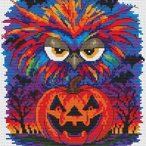 May include: A cross-stitch design featuring a colorful owl with orange, red, and blue feathers, set against a dark, spooky background. A carved orange pumpkin with a grinning face sits below the owl. Black bats and trees add to the Halloween theme.