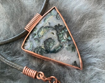 Rough Triangular moss agate stone w/ copper setting on leather cord.