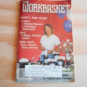 May include: The Workbasket magazine cover features a woman in a white top, with text including "Happy New Year!" and craft project titles like "Beaded Sweater" and "Tuxedo Party Servers." Balloons and floral arrangements are visible.