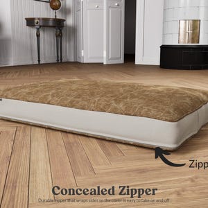 concealed zipper along the back that wraps sides so it's easy to take on and off as needed for washing.