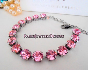 Pulsera con piedra de nacimiento de octubre: cristales de chatón rosa y cadena de acero quirúrgico.