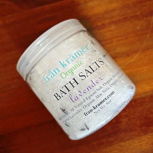 May include: A clear plastic jar of lavender bath salts. The label reads "från krämer Organic BATH SALTS lavender." The jar contains white salts with small lavender pieces. The net weight is 8oz.