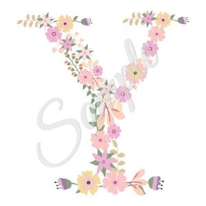May include: A floral letter Y made of pink, yellow, and purple flowers. The flowers are arranged in a wreath shape around the letter.