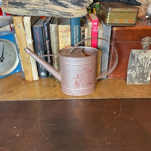 Vintage rusted children&#39;s watering can