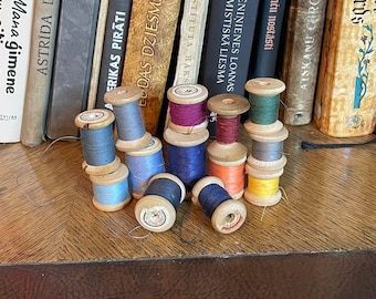 Vintage wooden thread spools with original threads. Set of thirteen.