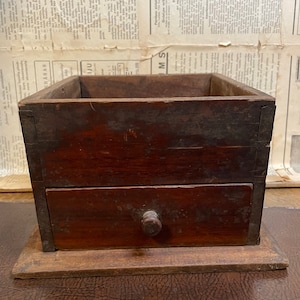 Vintage manual coffee grinder box with drawer.