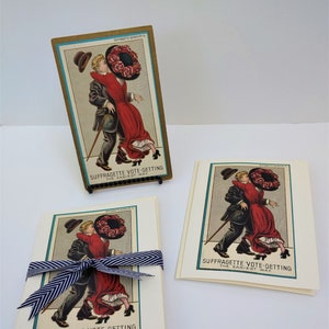 May include: A set of three vintage postcards featuring a couple in a humorous illustration. The postcards are cream colored with a blue and green border. The text on the postcards reads "Suffragette Vote-Getting The Easiest Way."