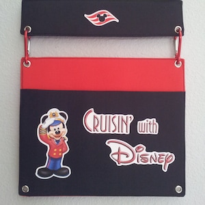 May include: Black and red fabric organizer with a Mickey Mouse character wearing a captain's hat and the text "Cruisin' with Disney".
