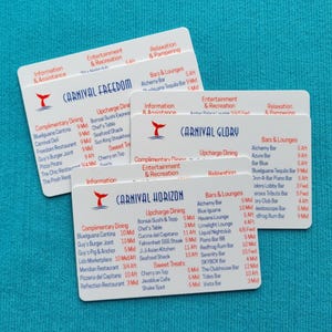 May include: Three white rectangular plastic cards featuring cruise ship deck plans for Carnival Freedom, Carnival Glory, and Carnival Horizon. Each card displays a red whale tail logo, blue text, and lists dining, entertainment, and bar locations.