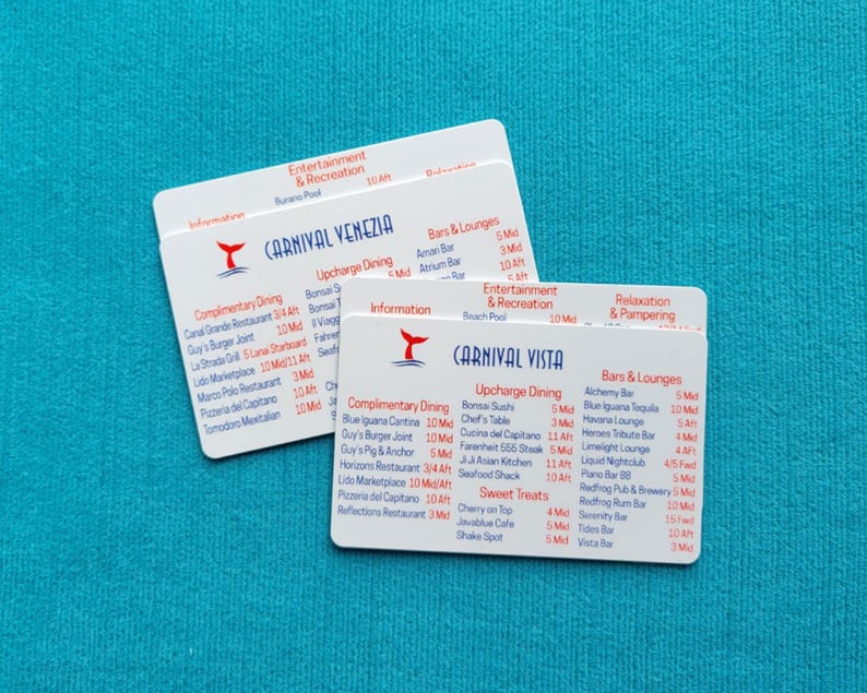 May include: Two white rectangular plastic cards featuring cruise ship deck plans. One card is labeled Carnival Venezia and the other Carnival Vista. Both cards list dining, entertainment, and bar locations with deck numbers and ship sections.