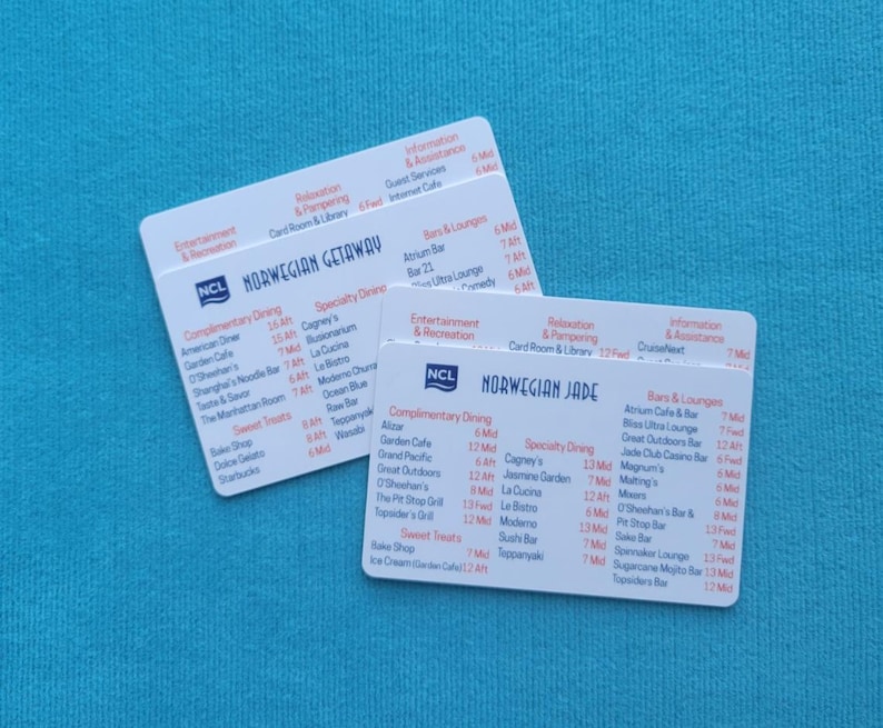 May include: Two white plastic cards with black text listing dining and bar options on a Norwegian Cruise Line ship. The cards are for the Norwegian Getaway and the Norwegian Jade.