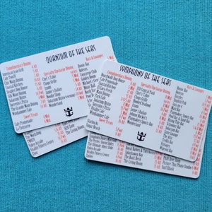 May include: Two white cards with red text listing dining options on a Royal Caribbean cruise ship. The cards are for Quantum of the Seas and Symphony of the Seas. The cards list complimentary dining, specialty dining, and bars and lounges.